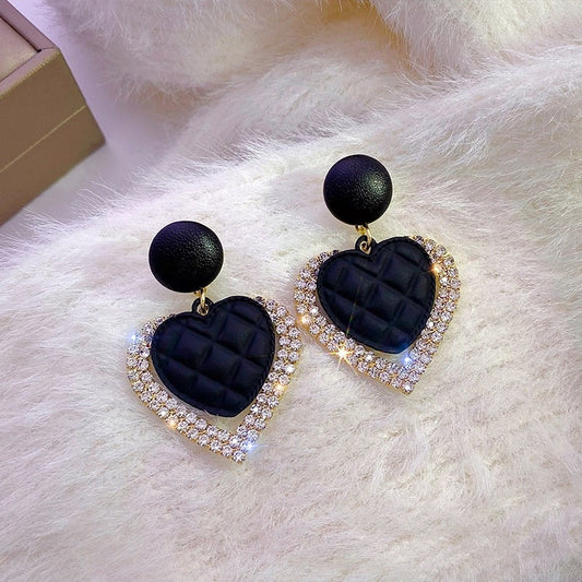 Pendientes de corazón negro dorados, vista 2