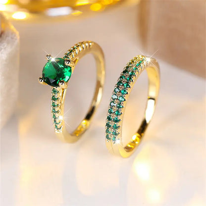 Set de dos anillos dorados con piedra verde